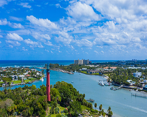 A red lighthouse overlooking a bay