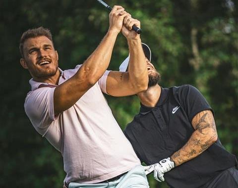 Two guys playing golf