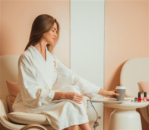 Woman sitting in a spa facility with a cup of tea