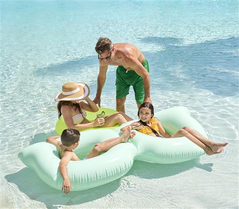 Family playing in pool