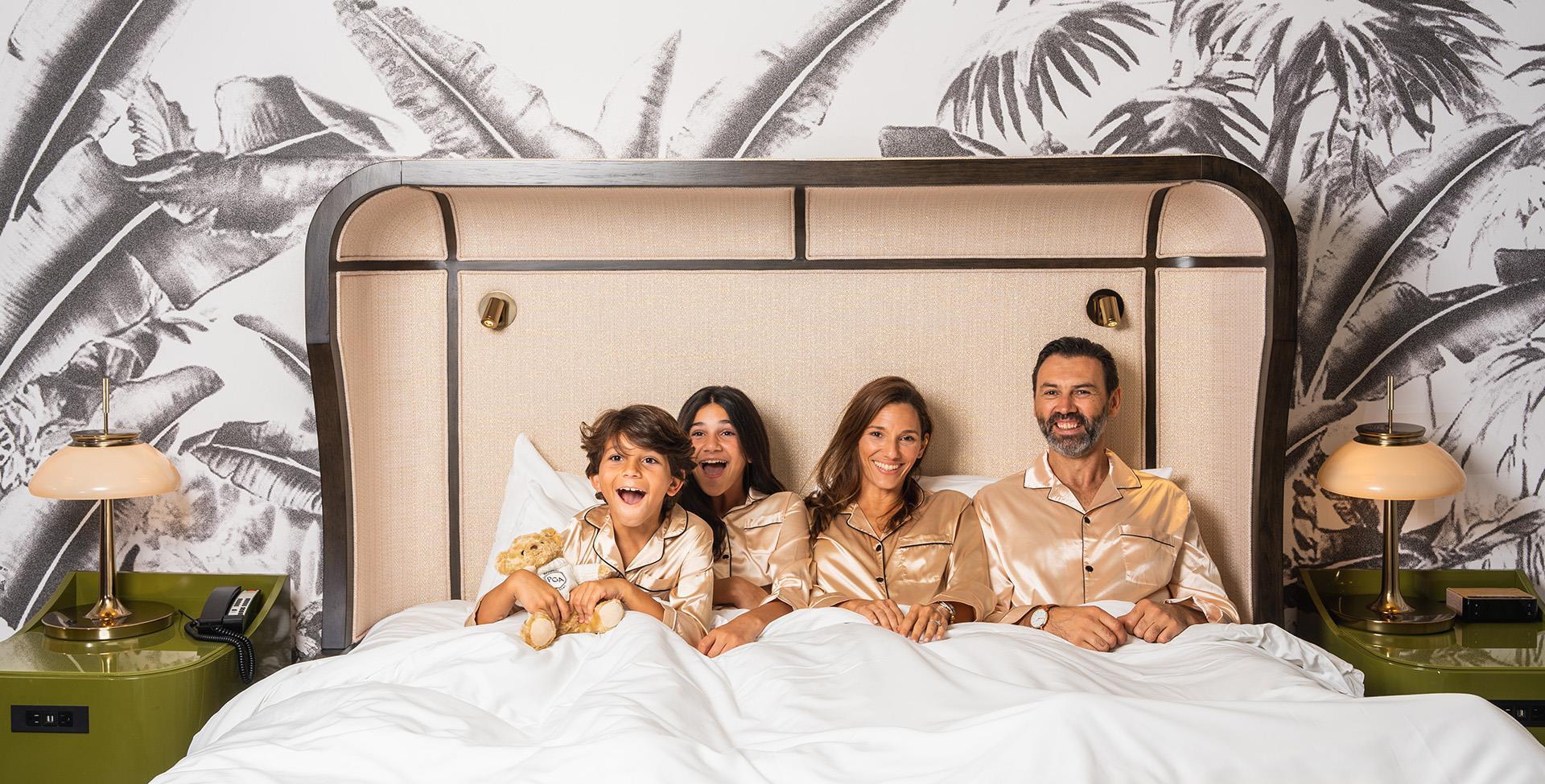 Family on a hotel bed