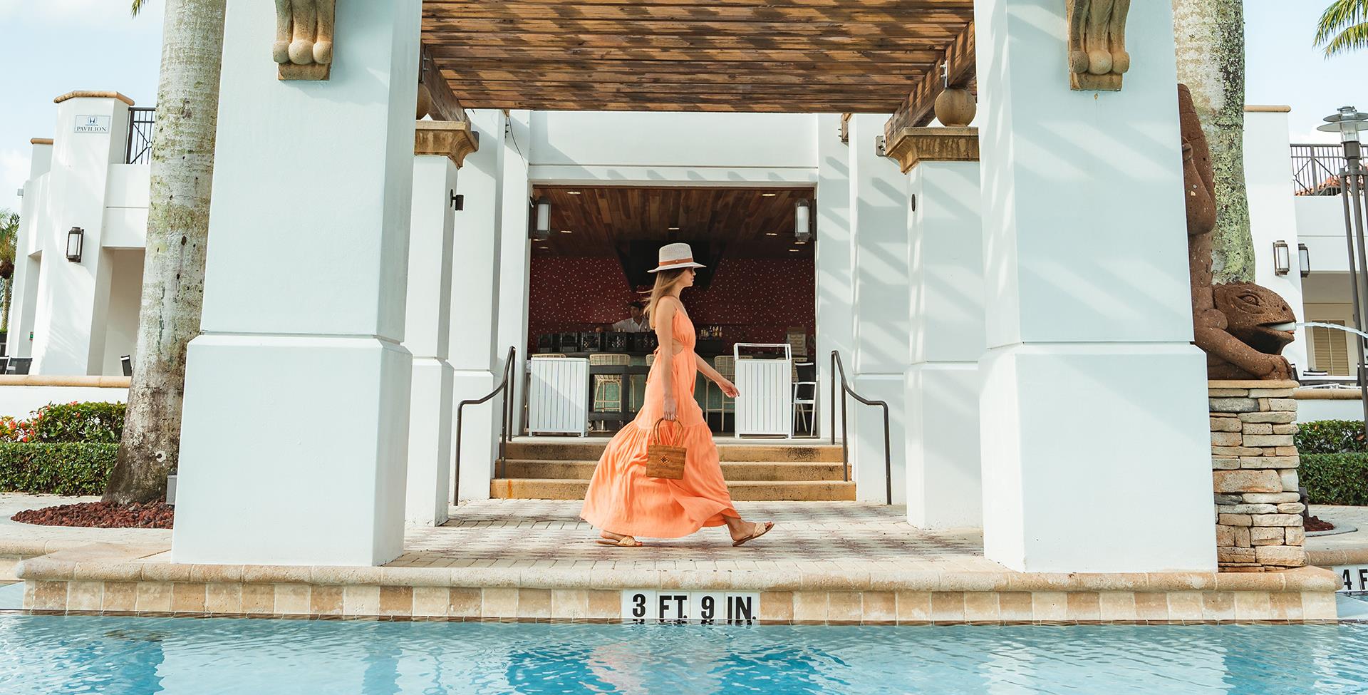 woman walking by the pool