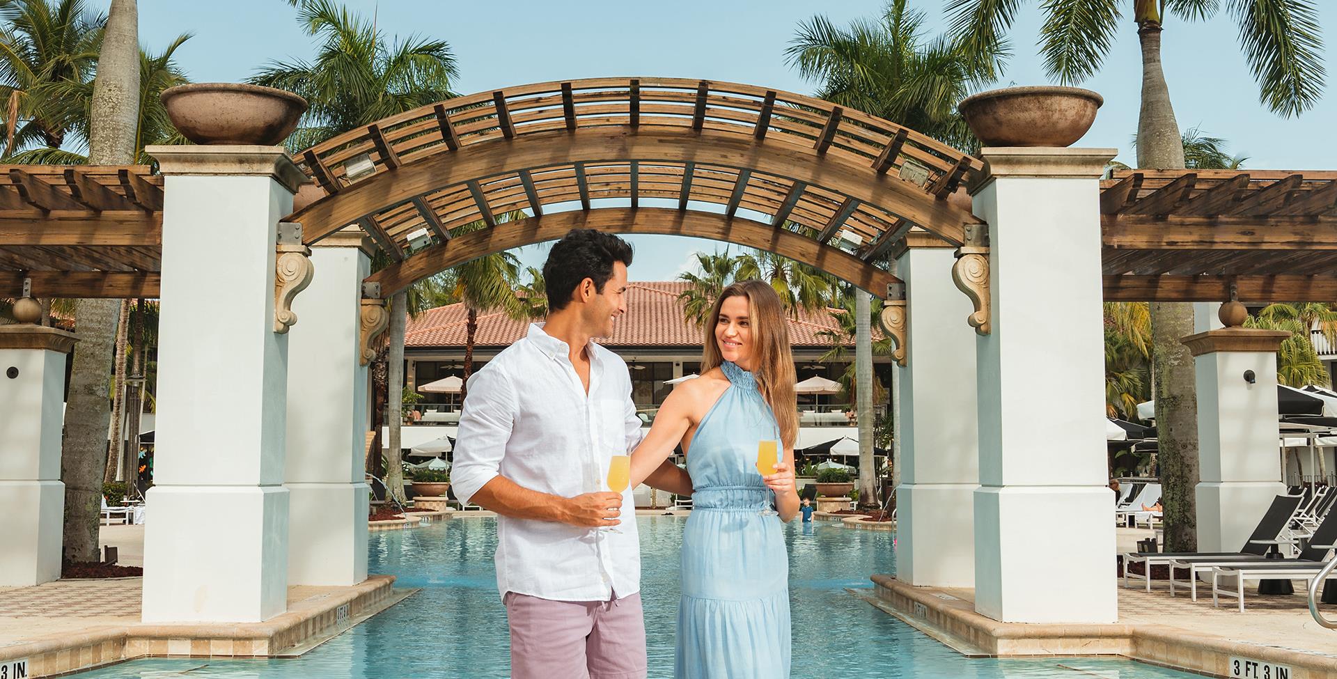 Couple walking next to pool