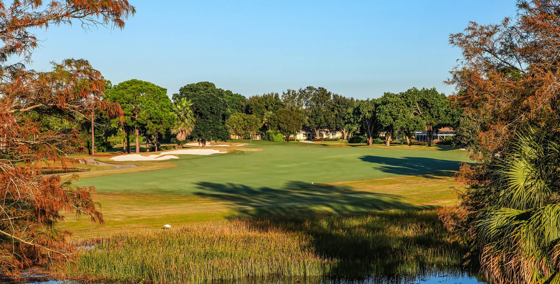 Golf course surrounded by orange leaves